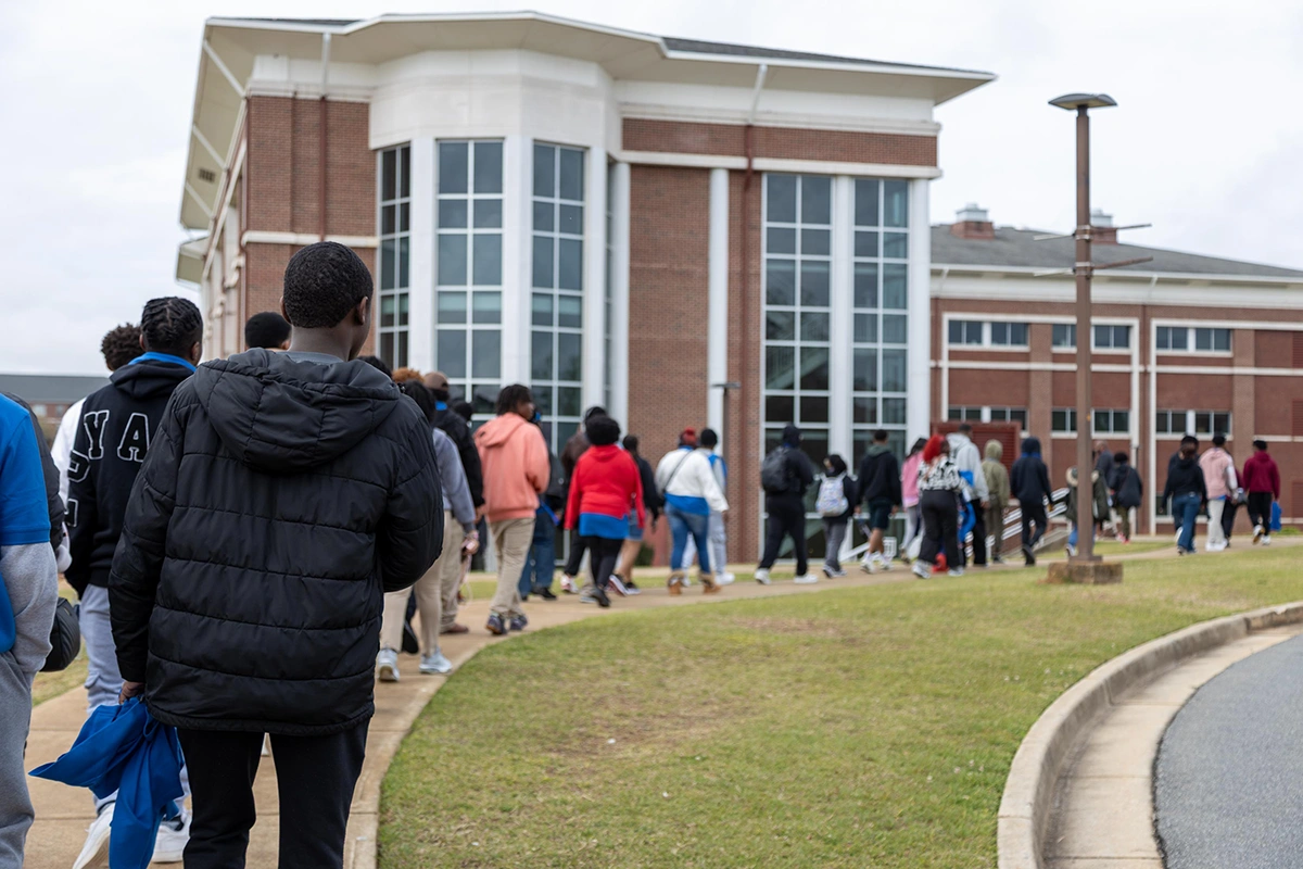 students in line entering a school building